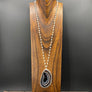 Brown and ivory agate slice on howlite necklace - silver