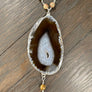 Brown and ivory agate slice necklace with shell horn - silver