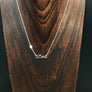 Full moon rising over a mountain range necklace
