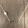 Full moon rising over a mountain range necklace