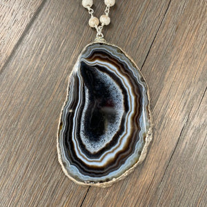 Brown and ivory agate slice on howlite necklace - silver