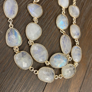 Rainbow moonstone on white leather - silver, gold