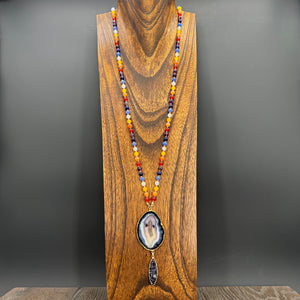 Multi-stone hand knotted necklace with agate slice + druzy pendant